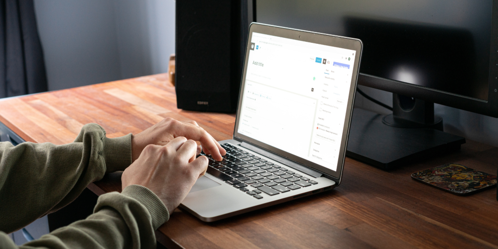 Laptop in the Table Opening WordPress Site